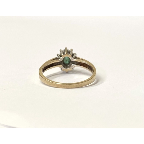 75 - A LOVELY 10CT YELLOW GOLD EMERALD AND DIAMOND CLUTSER RING, with central oval cut emerald in claw se... 