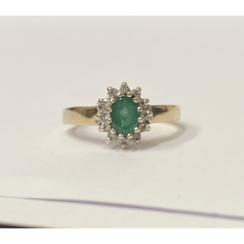 75 - A LOVELY 10CT YELLOW GOLD EMERALD AND DIAMOND CLUTSER RING, with central oval cut emerald in claw se... 