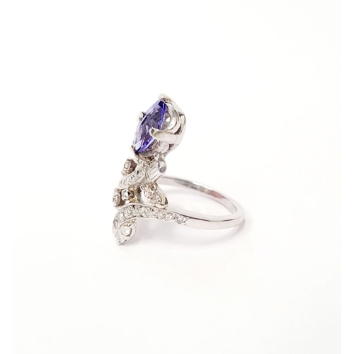 8 - A FANTASTIC VINTAGE TANZANITE & DIAMOND DRESS RING, with an oval shaped tanzanite stone held up on a... 