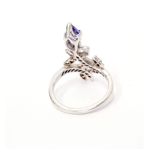 8 - A FANTASTIC VINTAGE TANZANITE & DIAMOND DRESS RING, with an oval shaped tanzanite stone held up on a... 