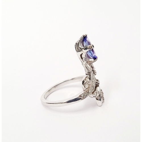 8 - A FANTASTIC VINTAGE TANZANITE & DIAMOND DRESS RING, with an oval shaped tanzanite stone held up on a... 