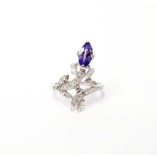 8 - A FANTASTIC VINTAGE TANZANITE & DIAMOND DRESS RING, with an oval shaped tanzanite stone held up on a... 