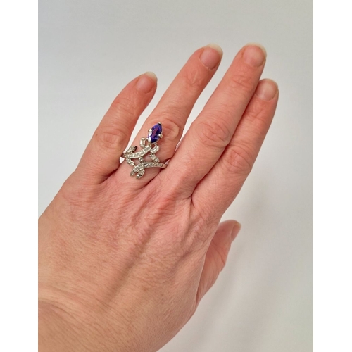 8 - A FANTASTIC VINTAGE TANZANITE & DIAMOND DRESS RING, with an oval shaped tanzanite stone held up on a... 