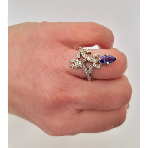 8 - A FANTASTIC VINTAGE TANZANITE & DIAMOND DRESS RING, with an oval shaped tanzanite stone held up on a... 