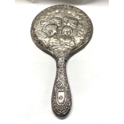 82 - A DECORATIVE SILVER HAND MIRROR, by Henry Matthews, Birmingham c.1929. The bevelled mirror with high... 