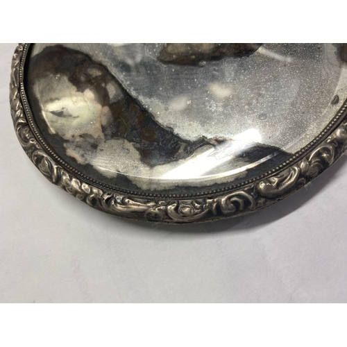 82 - A DECORATIVE SILVER HAND MIRROR, by Henry Matthews, Birmingham c.1929. The bevelled mirror with high... 