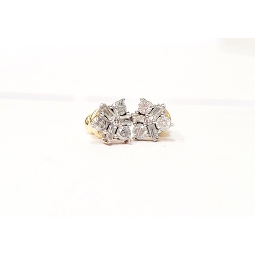 87 - A PAIR OF 9CT YELLOW GOLD BACKED SPARKLING FLORAL DESIGN DIAMOND CLUSTER STUD EARRINGS, with a mix o... 