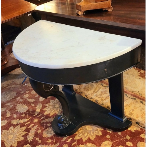 88 - A DEMI LUNE SHAPED MARBLE TOPPED CONSOLE TABLE / HALL TABLE, with carved scroll shaped upright suppo... 