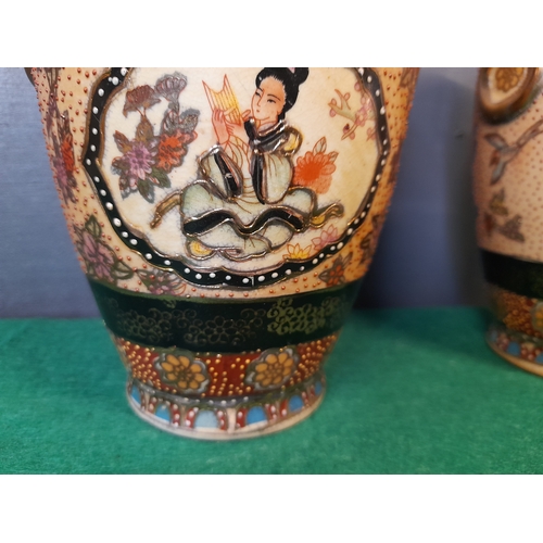 287 - A PAIR OF VINTAGE SATSUMA VASES, each with picture panels depicting a lady seated surrounded by flow... 