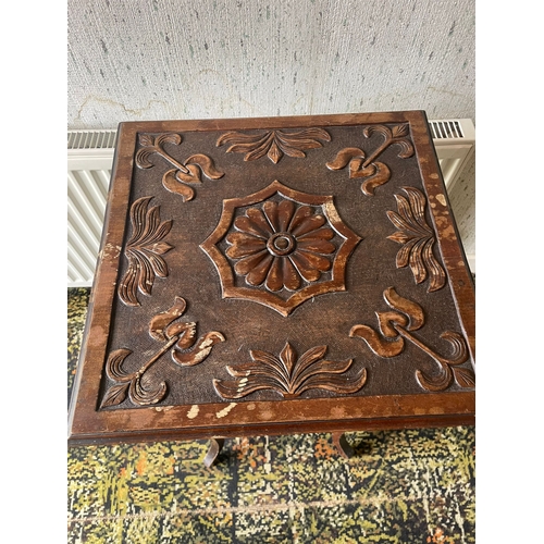 303 - AN EARLY 20TH CENTURY OCCASIONAL / SIDE TABLE, with carved floral design to the top, raised on cabri... 