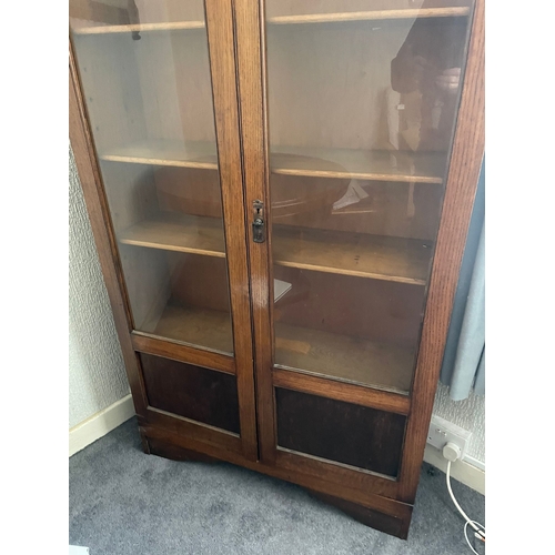 311 - AN IRISH MID-CENTURY BALFE’S OF DUBLIN OAK TWO DOOR GLAZED BOOKCASE, in very good condition, with ad... 