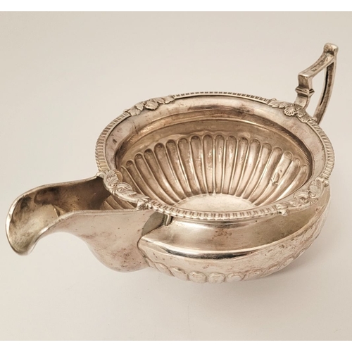 19 - AN IRISH EARLY 19TH GEORGE III SILVER CREAM JUG, with gadrooned rim having floral points, the body f... 