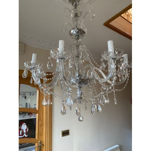 21 - A BEAUTIFUL CRYSTAL EIGHT BRANCH CHANDELIER, with cut glass support, eight scrolling branches with c... 