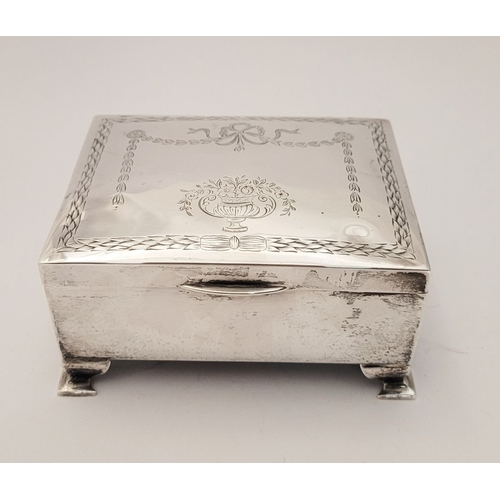 31 - AN EARLY 20TH CENTURY SILVER BOX, with hinged lid, the top decorated with bright cut decoration of r... 