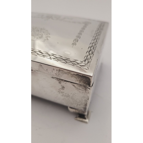 31 - AN EARLY 20TH CENTURY SILVER BOX, with hinged lid, the top decorated with bright cut decoration of r... 