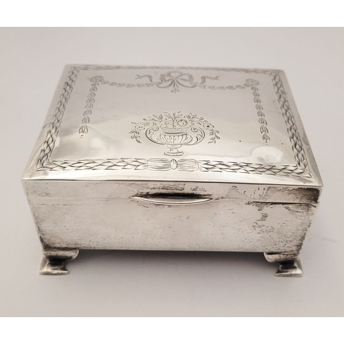 31 - AN EARLY 20TH CENTURY SILVER BOX, with hinged lid, the top decorated with bright cut decoration of r... 