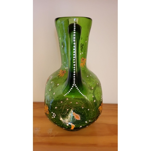 122 - A VINTAGE BOHEMIAN GREEN CRACKLE GLASS ENAMEL PAINTED JUG, with white enamel bead detail the handle,... 