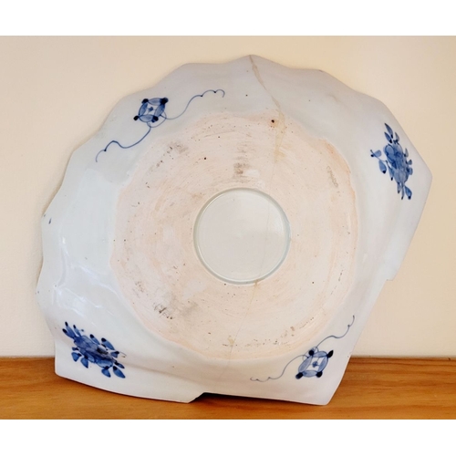 123 - A VINTAGE IMARI FAN SHAPED PLATE, with typical blue & red design. Old hairline mend to the base – ph... 