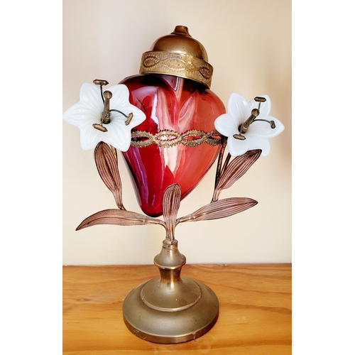 126 - AN UNUSUALLY PAIR OF SACRED HEART VOTIVE LAMPS, each with a cranberry red glass heart that rests wit... 