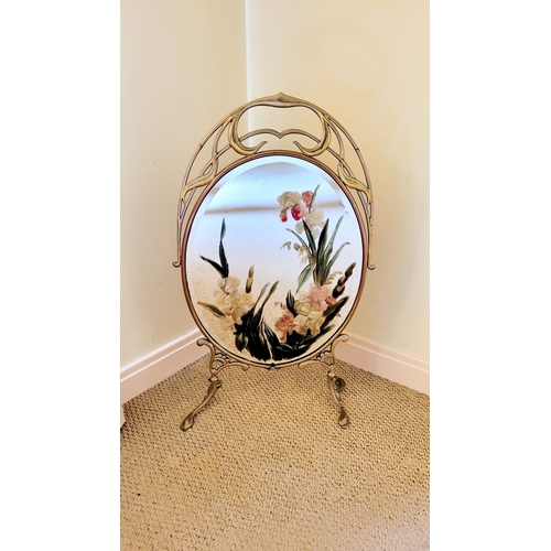 127 - AN ART NOUVEAU BRASS FRAMED MIRRORED FIRE SCREEN, with hand painted floral decoration to the bevelle... 