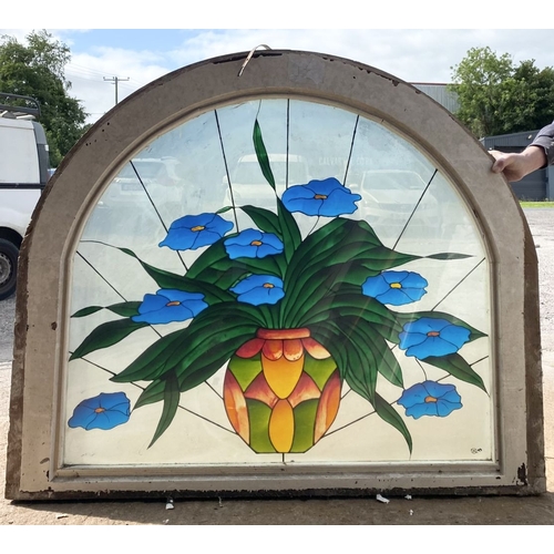 130 - A BEAUTIFUL ARCHED STAINED GLASS WINDOW, c.1993, with blue flowers in vase in vibrant colours, signe... 