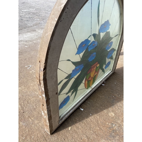 130 - A BEAUTIFUL ARCHED STAINED GLASS WINDOW, c.1993, with blue flowers in vase in vibrant colours, signe... 