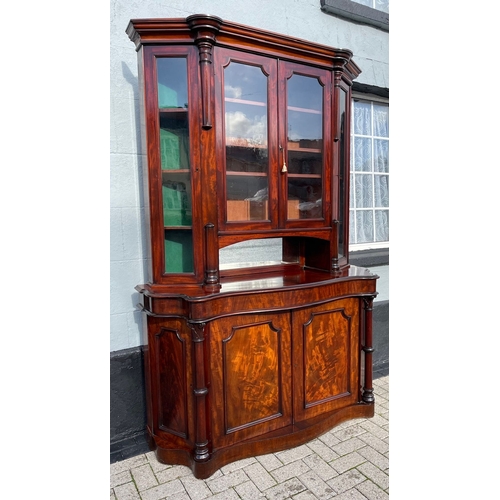 17 - A STUNNING QUALITY IRISH FLAME MAHOGANY SERPENTINE SHAPED BOOKCASE, after Robert Strahan Dublin. Wit... 