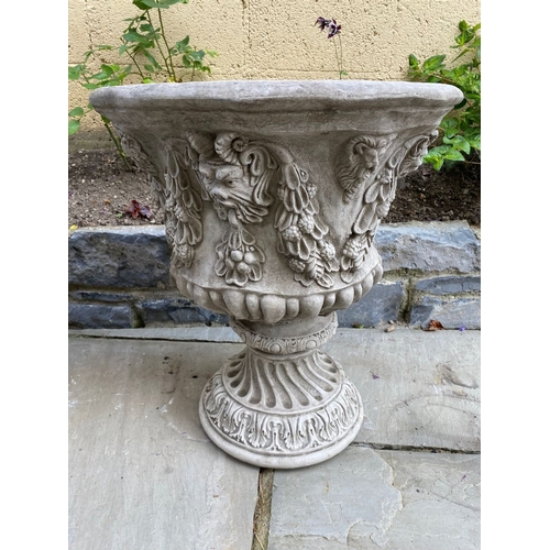 24 - A LARGE PAIR OF STONE BACCHUS DESIGN GARDEN URNS, highly decorated throughout, dimensions: 52cm diam... 