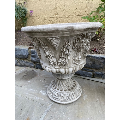 24 - A LARGE PAIR OF STONE BACCHUS DESIGN GARDEN URNS, highly decorated throughout, dimensions: 52cm diam... 