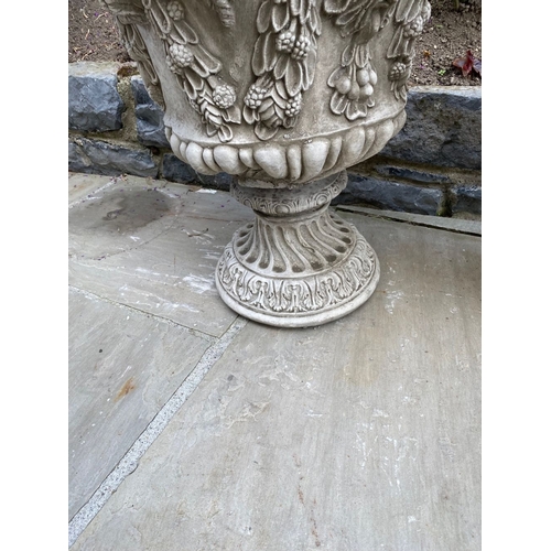 24 - A LARGE PAIR OF STONE BACCHUS DESIGN GARDEN URNS, highly decorated throughout, dimensions: 52cm diam... 