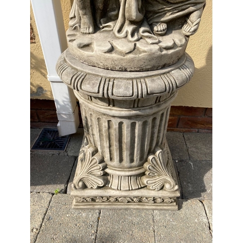 31 - A LARGE STONE GARDEN ORNAMENT IN THE FORM OF MOTHER AND CHILD, child holding birdbath, both raised o... 