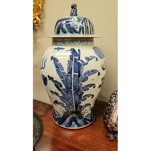 34 - A CHINESE BLUE & WHITE TEMPLE VASE, with domed cover having a lion finial, the vase is painted in bl... 