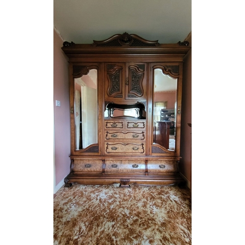 38 - A VERY LARGE VICTORIAN WALNUT ARMOIRE / WARDROBE UNITE, with a raised carved pediment top, to the le... 