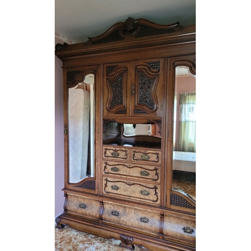 38 - A VERY LARGE VICTORIAN WALNUT ARMOIRE / WARDROBE UNITE, with a raised carved pediment top, to the le... 