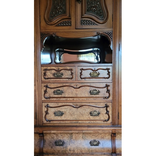 38 - A VERY LARGE VICTORIAN WALNUT ARMOIRE / WARDROBE UNITE, with a raised carved pediment top, to the le... 