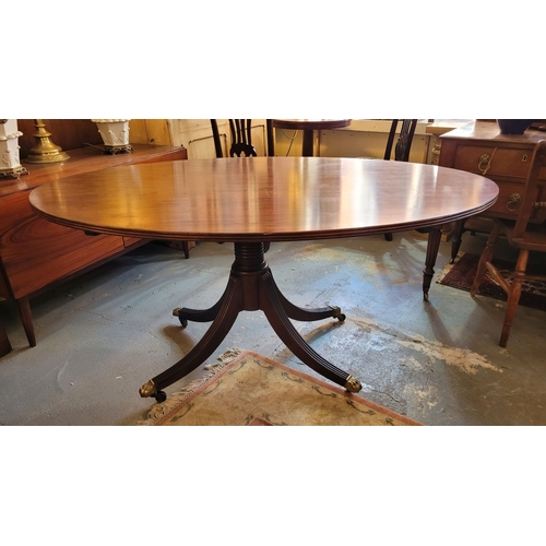 46 - A VERY FINE MAHOGANY OVAL SHAPED DINING TABLE, with reed detail to the edge, raised on a turned colu... 