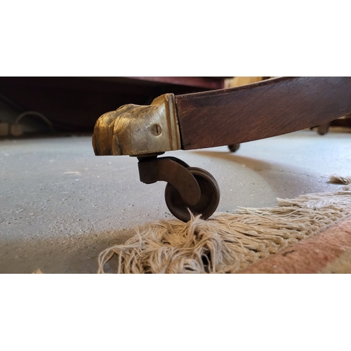 46 - A VERY FINE MAHOGANY OVAL SHAPED DINING TABLE, with reed detail to the edge, raised on a turned colu... 