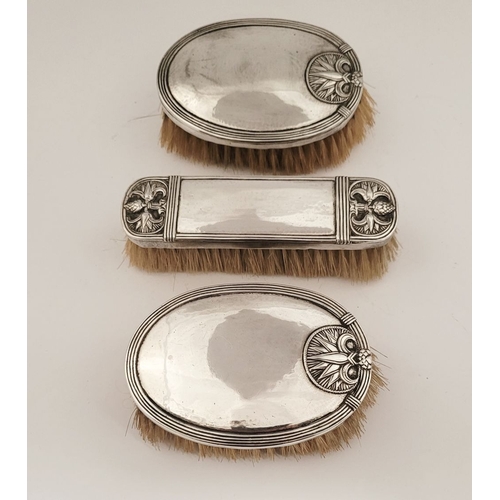 54 - A LOVELY SET OF SILVER TOPPED CLOTHES BRUCHES, two oval shaped & one rectangular; each with lovely a... 