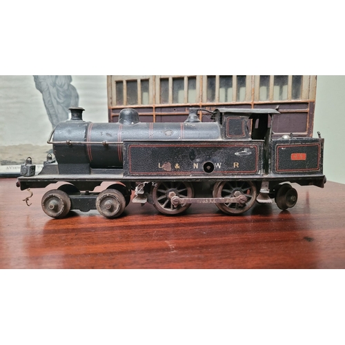 64 - TWO ANTIQUE TOY TRAIN / MODEL TRAIN PIECES: (i) A CLOCKWORK LOCOMOTIVE –maker not confirmed – possib... 