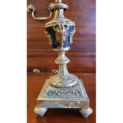 79 - A PAIR OF DECORATIVE BRASS GARNITURES – FOUR HEAD CANDELABRA, each with three outer candle holders a... 