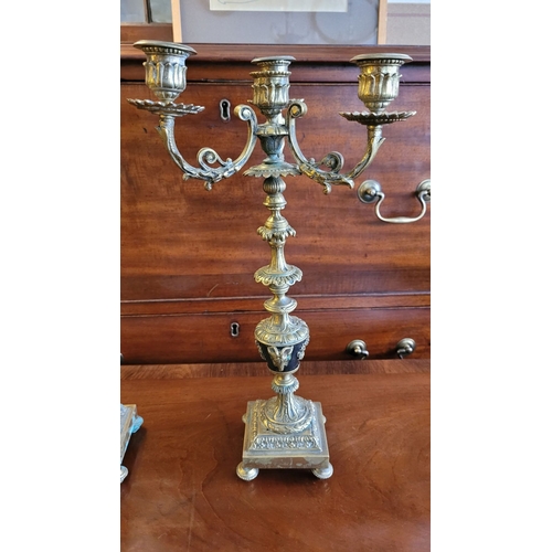 79 - A PAIR OF DECORATIVE BRASS GARNITURES – FOUR HEAD CANDELABRA, each with three outer candle holders a... 