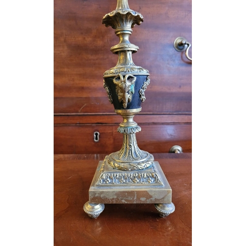 79 - A PAIR OF DECORATIVE BRASS GARNITURES – FOUR HEAD CANDELABRA, each with three outer candle holders a... 