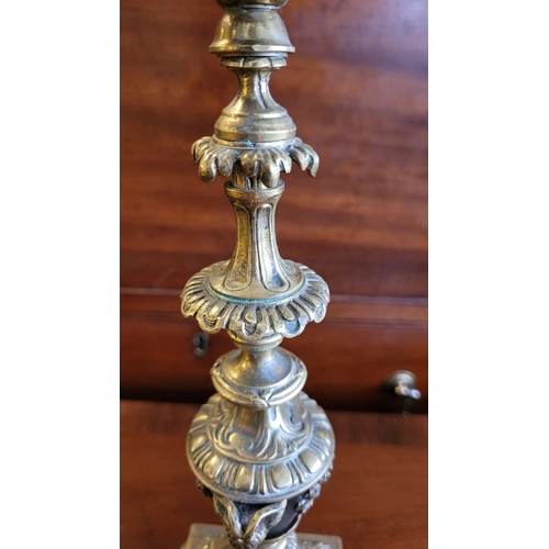 79 - A PAIR OF DECORATIVE BRASS GARNITURES – FOUR HEAD CANDELABRA, each with three outer candle holders a... 