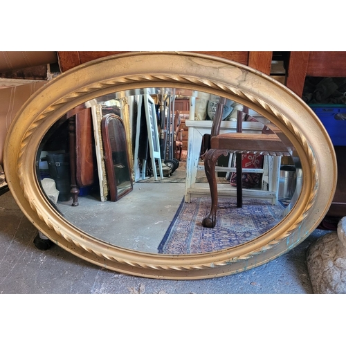 80 - A VERY GOOD QUALITY OVAL GILT WALL MIRROR – lovely ripple to the old mirror pane, with bevelled edge... 