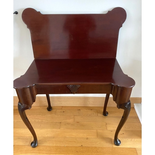 83 - AN IRISH MAHOGANY CARD TABLE, top with porringer corners, above frieze with shell motif to centre. S... 