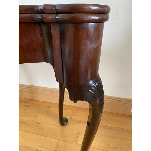 83 - AN IRISH MAHOGANY CARD TABLE, top with porringer corners, above frieze with shell motif to centre. S... 