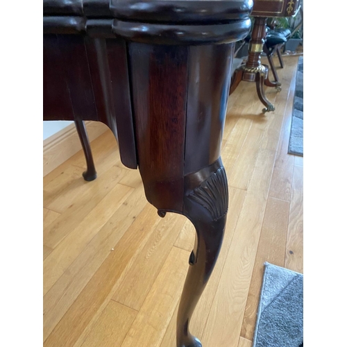 83 - AN IRISH MAHOGANY CARD TABLE, top with porringer corners, above frieze with shell motif to centre. S... 