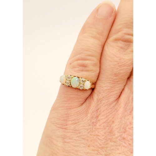 107 - A VERY GOOD QUALITY VICTORIAN ERA 18CT YELLOW GOLD OPAL & DIAMOND RING, with four round cut diamonds... 