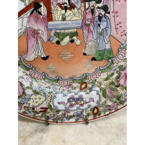 17 - A LARGE CHINESE FAMILLE ROSE MEDALLION PLATE, Qianlong period. Finely decorated with hand painted pa... 