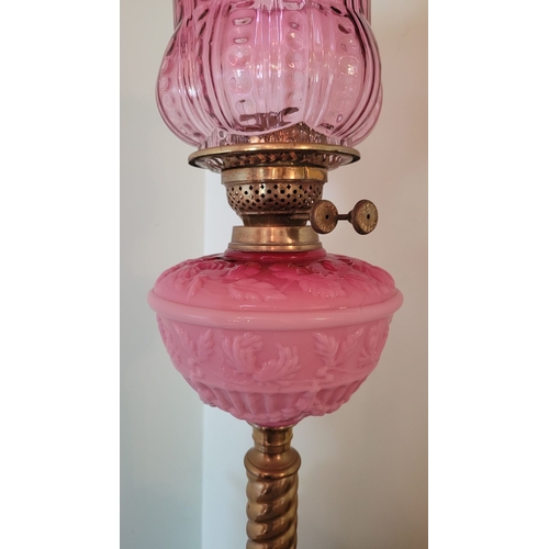 30 - A GOOD QUALITY VICTORIAN PILLAR OIL LAMP, raised on a circular ceramic base, complete with a barley ... 